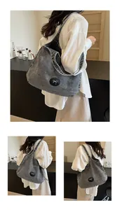 Macro detail of dark wash denim tote bag featuring white bow embroidery and large capacity
