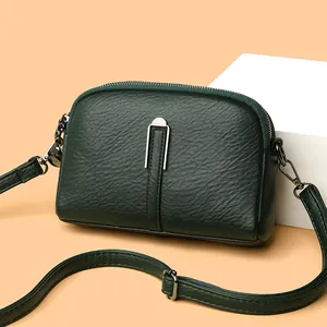 Minimalist dark green shell shoulder bag with litchi grain texture and silver hardware