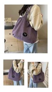 Detail of purple washed denim tote bag with white bow appliqué and large capacity