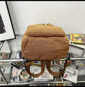Detail view of the washed canvas backpack back with adjustable straps and zipper