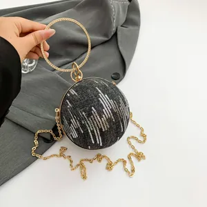 Spherical denim evening bag with sparkling sequins and diamond-encrusted metal handle