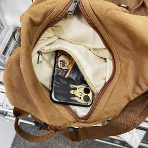 Brown canvas backpack interior view with main compartment and zipped inner pocket