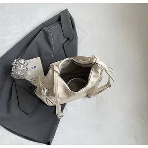 Top view of cream leather tote showing spacious interior with pocket and drawstring detail