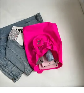 Spacious pink nylon tote bag showing interior capacity for phone, umbrella and gadgets
