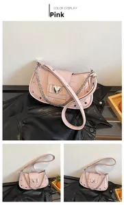Detailed view of pink crocodile-patterned purse with heart buckle and silver chain strap