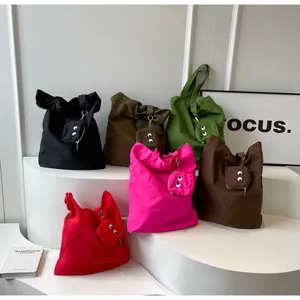 Detailed view of colorful canvas tote bags with cute cartoon monster eye embroidery charms