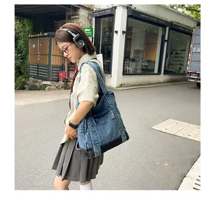 Lifestyle view of large denim tote bag with functional pockets and contrast stitching