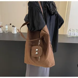 Caramel brown tote bag with pleated texture and cute monster coin purse detail