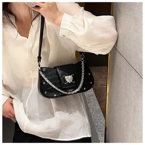 Black crocodile pattern underarm bag featuring a large silver heart buckle and chain detail