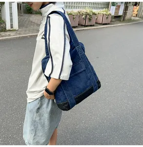 Close-up of deep blue denim tote bag with functional pockets and reinforced base