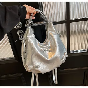 Detail of silver metallic tote with pleated texture and decorative ribbon bows