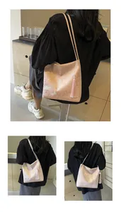 Detail of pink jacquard fabric shoulder bag with classical floral patterns and long tassels