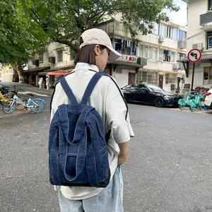 Versatile dark blue denim backpack and tote bag for women with durable black base