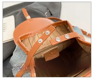 Detail showing magnetic snap closure and striped interior lining of large capacity backpack