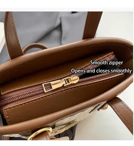Detail view of the smooth zipper closure and woven texture on a stylish tote bag
