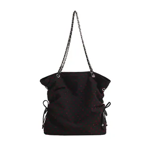 Black tote bag with red heart print featuring silver chain straps and side bows