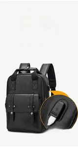Detail of external USB charging port on a black litchi pattern PU leather backpack