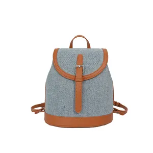 Chic blue denim backpack with brown leather trim and metal buckle for women
