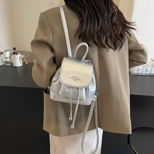 Silver mini faux leather backpack with drawstring closure and lychee texture