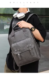 Outdoor model display of a grey lychee pattern PU leather backpack with vintage design