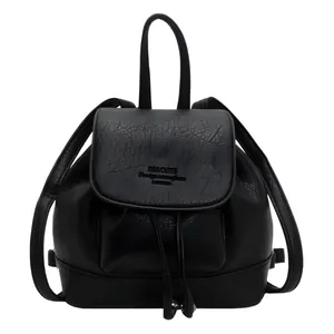 Minimalist black soft leather backpack with drawstring closure and top handle strap
