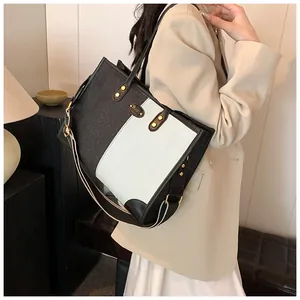 Detailed side view of large contrast tote bag with stylish wide striped shoulder strap