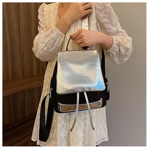 Detail of silver metallic flap and black nylon texture on a stylish women backpack