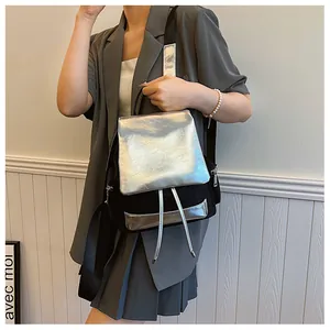 Detail of silver metallic leather flap and black nylon texture on a stylish backpack