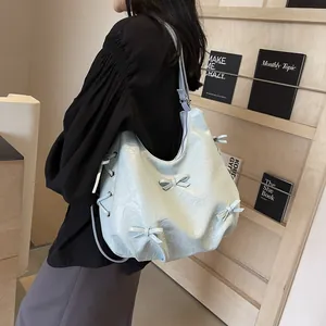 Light blue ruffle cloud tote bag with bow details and drawstring for casual style