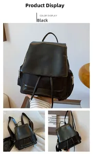 Detail view of black nylon backpack with PU leather trim and drawstring closure