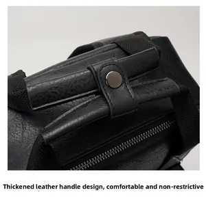 Close-up of thickened black leather top handle with matte metal buckle on backpack