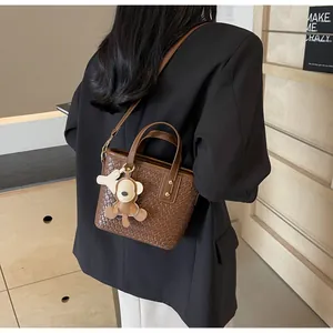 Detailed macro view of brown woven texture on tote bag with a cute monkey charm