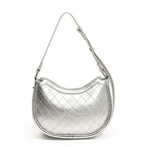 Silver metallic quilted crescent underarm bag with adjustable leather shoulder strap