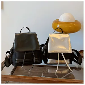Detail of color-block nylon backpack featuring drawstring closure and side zipper pocket