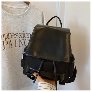 Detail of black contrast large capacity backpack with drawstring closure and PU leather base