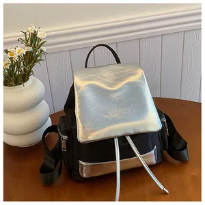 Close-up of contrast large-capacity backpack in black nylon and metallic silver finish