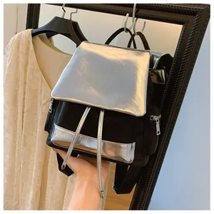 Detailed shot of black and silver contrasting backpack with drawstring and metal zippers