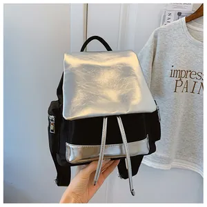 Close-up of contrast color backpack with silver metallic flap and drawstring closure