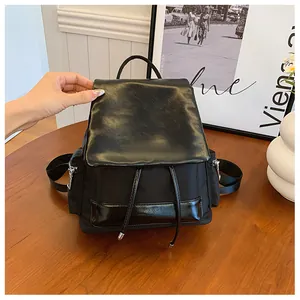 Detail of contrast stitching and mixed materials on stylish black backpack for women