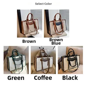 Detail view of large canvas tote bag showing two-tone contrast and faux leather handles