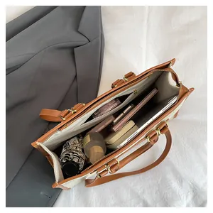 Top view of the spacious interior of a canvas tote bag with multi-compartment storage