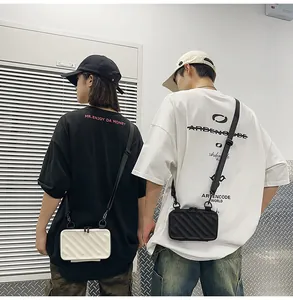 Mini suitcase crossbody bags in black and white with textured hardshell and nylon straps