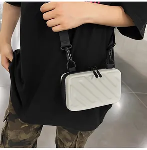 Detail of white striped hard shell crossbody bag with adjustable black nylon strap on model