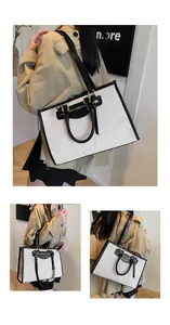 Detail of canvas tote bag showing contrast leather trim and spacious interior layout
