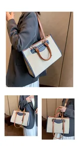 Detail of canvas tote bag with leather trim showing shoulder strap and handles