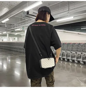 White hardshell mini crossbody bag with vertical stripe design and black nylon strap