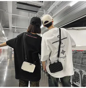 Rear view of models wearing mini hard shell crossbody bags with vertical striped texture