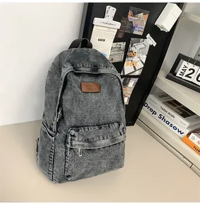 Détail macro de la texture du denim lavé et de l'étiquette en cuir sur le sac à dos
