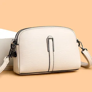 Off-white lychee texture leather crossbody bag with double zippers and metal detail