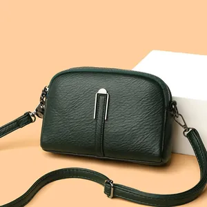 Dark green crossbody bag in lychee pattern leather with silver U-shaped metal buckle